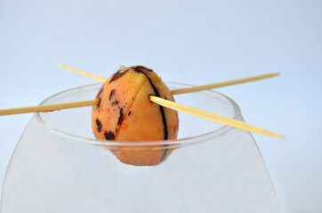   Avocado seed in a mug on a white background. Growing from seed. Isolate  
