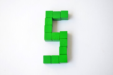 Number five from green cubes on a white background.