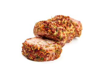 Raw meat patties with spices, four pork cutlets isolated on white