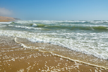 Sand beach and ocean waves. Beautiful seascape background. Relaxation, vacation, summer, tropical beach, horizon over the sea concept