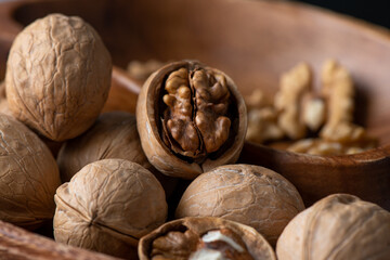 Heap of splited walnuts on rustic wooden table