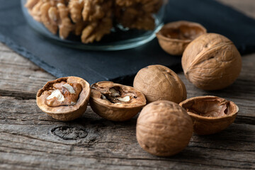 Heap of splited walnuts on rustic wooden table