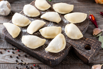 Fototapeta na wymiar Homemade dumplings - Russian dumplings. Meat dumplings. Dumplings with stuffing.