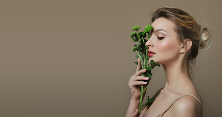 Portrait Young Woman Natural Makeup Woman Holding Green Flower Hand Natural cosmetics. Cosmetology and rejuvenation.