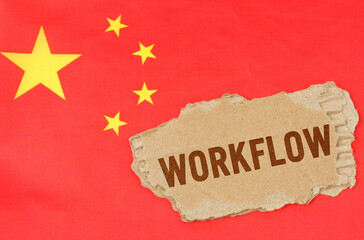 Against the background of the Chinese flag lies cardboard with the inscription - workflow