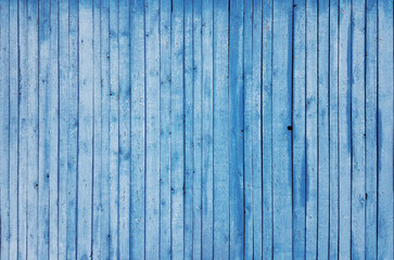 Fototapeta na wymiar fragment of blue weathered or vintage wooden fence or building facade, texture or wallpaper