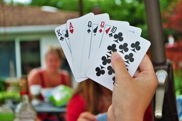 Over the shoulder view of a young woman playing cards
