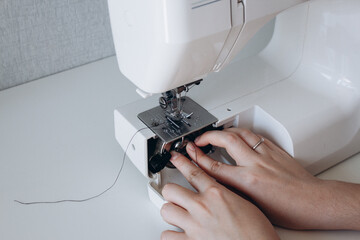 preparing the sewing machine for work. threading the bobbin into the sewing machine. hobby and work...