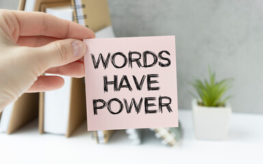 Words have power - inspirational handwriting in a notebook on wooden table with pen, crumpled paper and paper clips, communication and influence concept