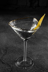 Glass margarita alcohol coctail drink with citrus on a gray background. Chalet.