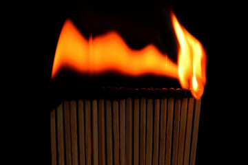 Matches burn one by one, black background