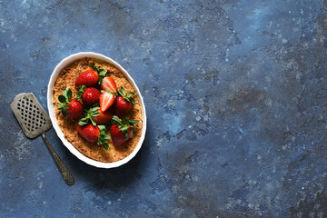 Cheesecake with ricotta and strawberries on a concrete background. View from above. Casserole.