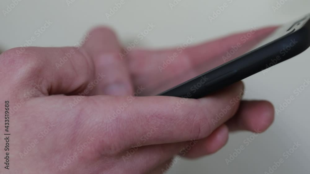 Poster a 4k rendering of a man texting a message with a black smartphone