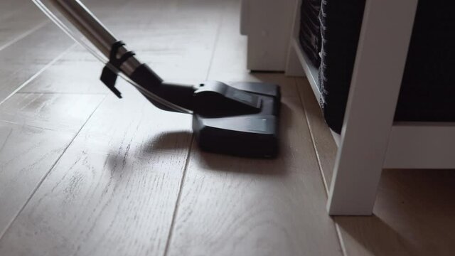 Vacuuming the light oak floor with water. Wet cleaning of housing. Technologies that facilitate cleaning. Modern household appliances