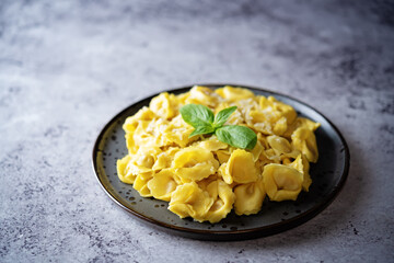 Fresh prepared Tortellini pasta with basil in a plate