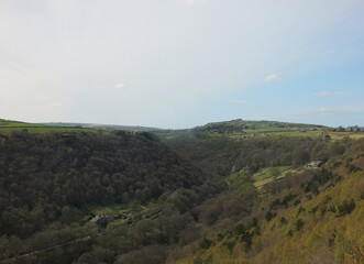 Fototapeta premium view along the colden valley in calderdale near hebden bridge with the village of colden on the hills above the woodland