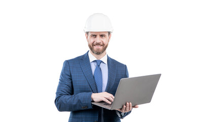 happy man in suit and safety helmet wotking on computer online isolated on white, agile business.