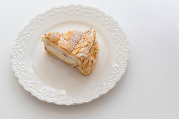 Sponge cake on a white plate on the table. Top view - flat lay