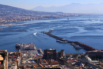 Panoramic view of Naples from the Castel Sant Elmo with, in the foreground, the Castel Nuovo and the Maritime Station, against to the profile of the Vesuvius volcano during a sunny winter day.