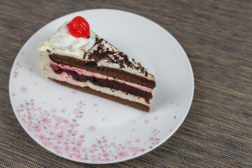 Chocolate cake with berries on a white plate.
