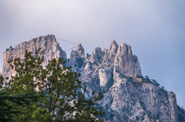 High rocky mountains with forested slopes and peaks hidden in the clouds. Ai-Petri, Crimea