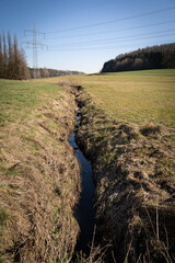 Narrow stream in the field 