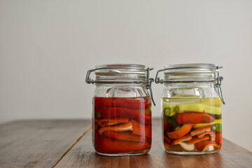 Homemade food: different kind of peppers ready to ferment in a mason jar