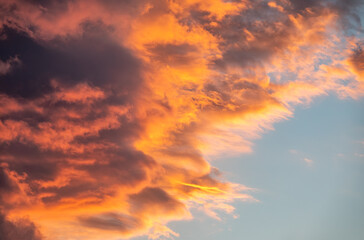 Beautiful orange sunset in the cloudy sky
