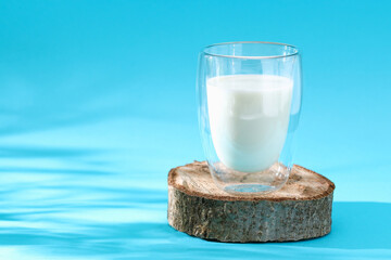 Glass of milk on a blue background. Milk products.