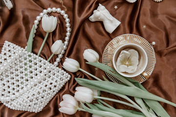 Flat lay fashion collage with women accessories. Bouquet of spring white tulips .The concept of valentine's day and women's day.