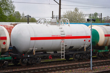 Fototapeta na wymiar Tank cars train for transportation liquefied petroleum gas and deliver LNG by rail.Transportation of petroleum products, safety storage. LPG railroad tanks, export of liquefied natural gas.