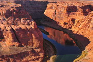 The Colorado river winds through deep cliff and plateaus in the Arizona Desert