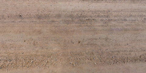 view from above on car tire tracks on texture of gravel road
