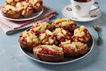 Homemade hot sandwiches with sausage, cheese and pineapple. Delicious breakfast or snack. Close-up