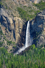 The Majestic Granite rock face of half dome and the Yosemite waterfall in the valley of Yosemite Natinal Park on a Spring day