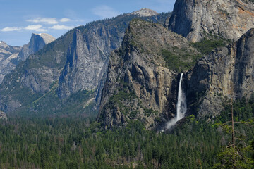 The Majestic Granite rock face of half dome and the Yosemite waterfall in the valley of Yosemite Natinal Park on a Spring day