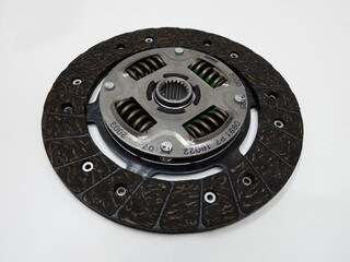 Auto parts: isolated close-up photo of new clutch plate on a white background