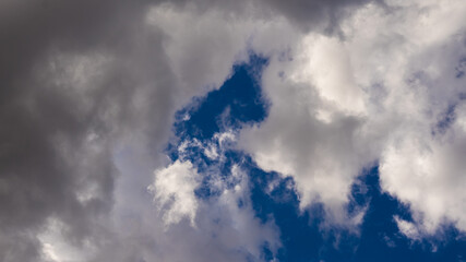 Fluffy and white clouds, blue sky in a sunny day