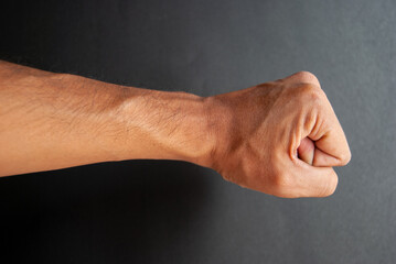 Obraz na płótnie Canvas fist of a man on black background