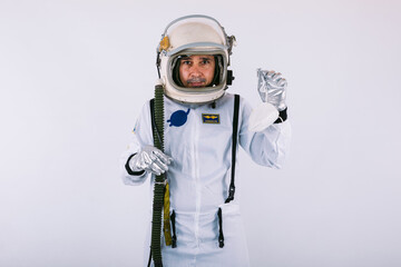 Male cosmonaut in spacesuit and helmet, holding a FPP2 mask, on white background. Covid-19 and virus concept