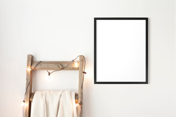 Modern, vertical, 16x20 black frame mockup hanging on a wall. Wooden blanket ladder with globe...