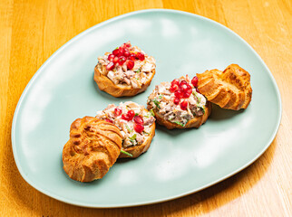 canape with meat salad and pomegranate seeds