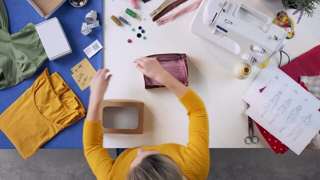 Top view of woman preparing a package, coronavirus desktop concept.