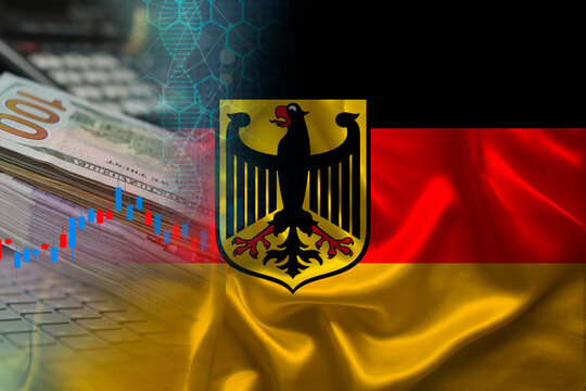 national flag of Germany on satin, dollar bills, computer, concept of global trading on the stock exchange, falling and rising prices for world currency