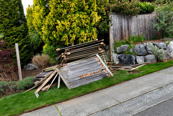 Old wooden fence being tore down to prepare to install new one - 433537499