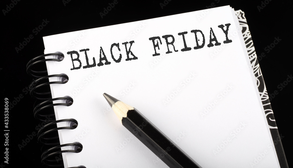 Poster black friday written text in small notebook on a black background