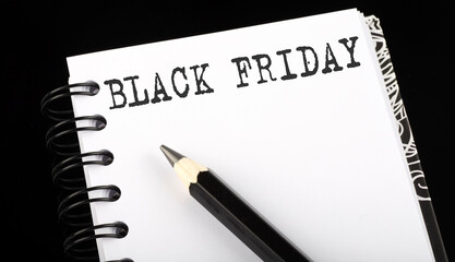 Black Friday written text in small notebook on a black background