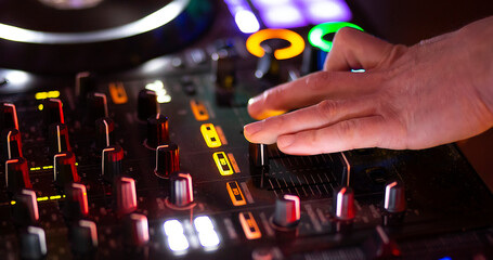 dj play on music console in nightclub