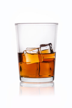 Glass of whiskey and ice isolated on white background.