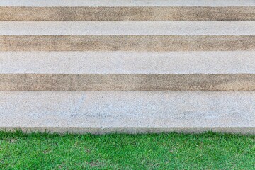 Brown terrazzo steps and green lawn outside the house